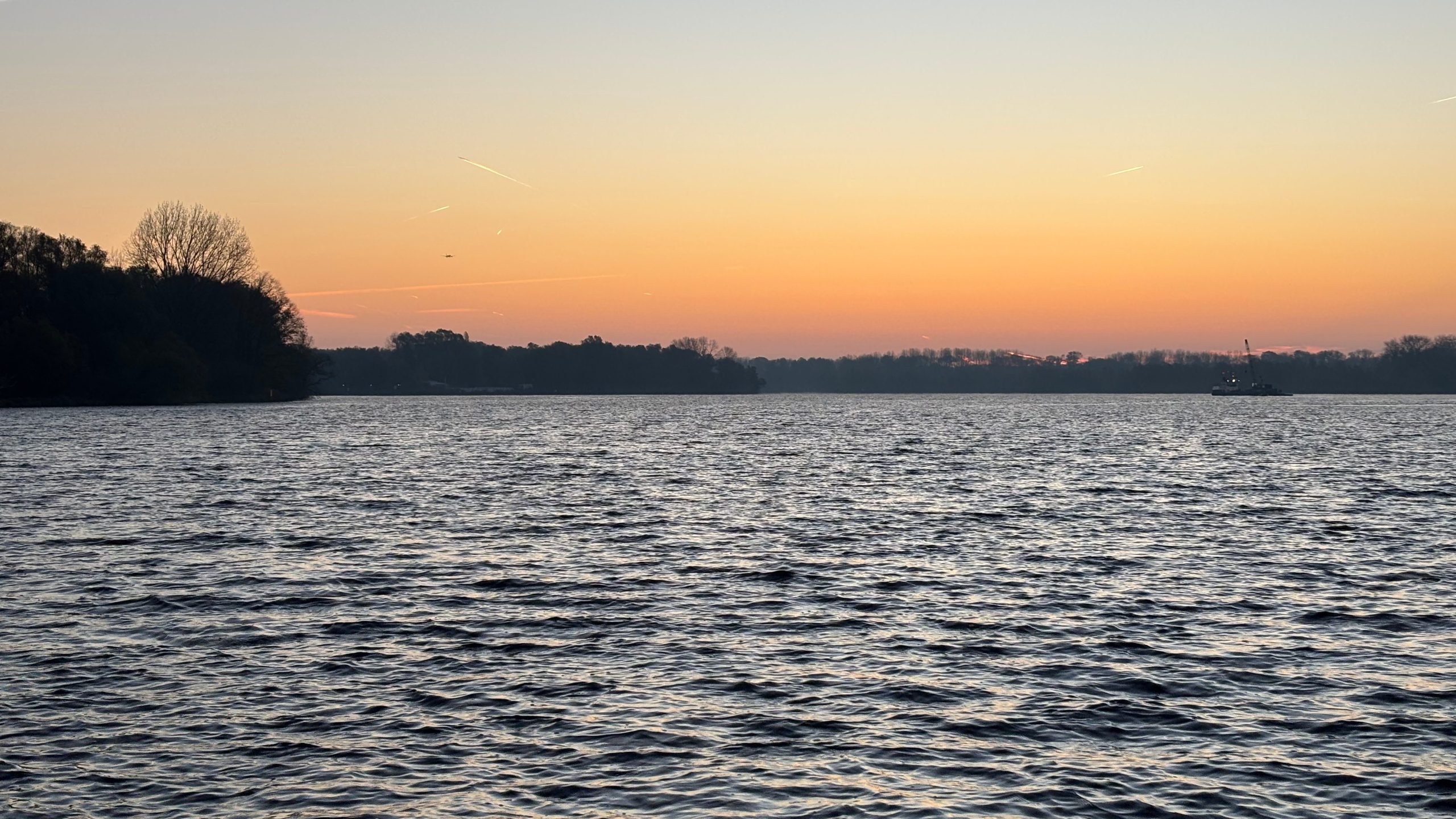 Image of Nieuwe Meer lake with sunset skies in distance 